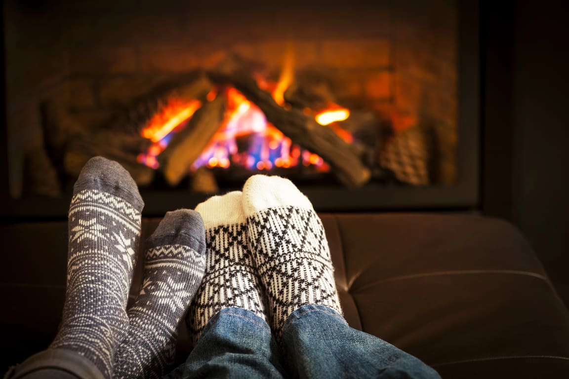 Socks beside a gas fireplace