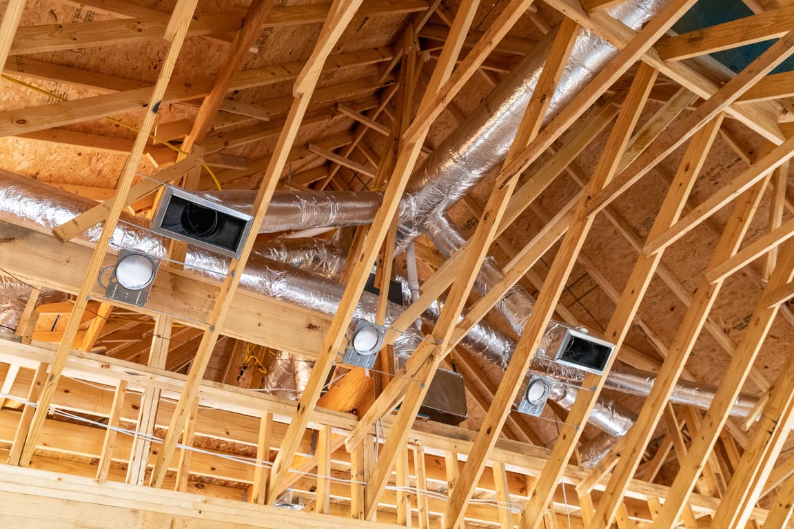 Flexible ductwork running between attic trusses