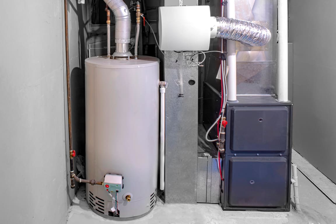 Gas furnace beside a water heater in a utility room