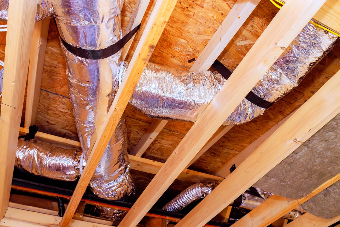 Foil flex duct running between floor joists