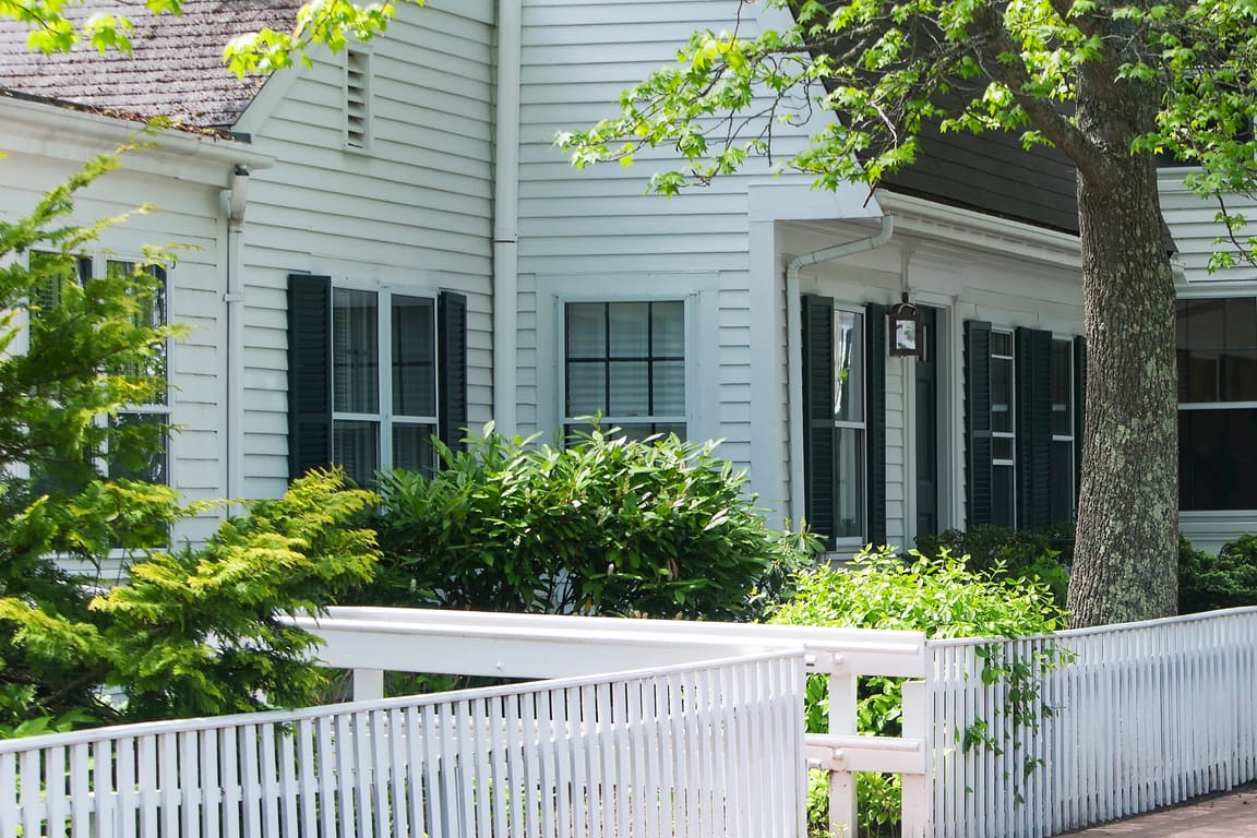 White clapboard houses and picket fences on a New England street