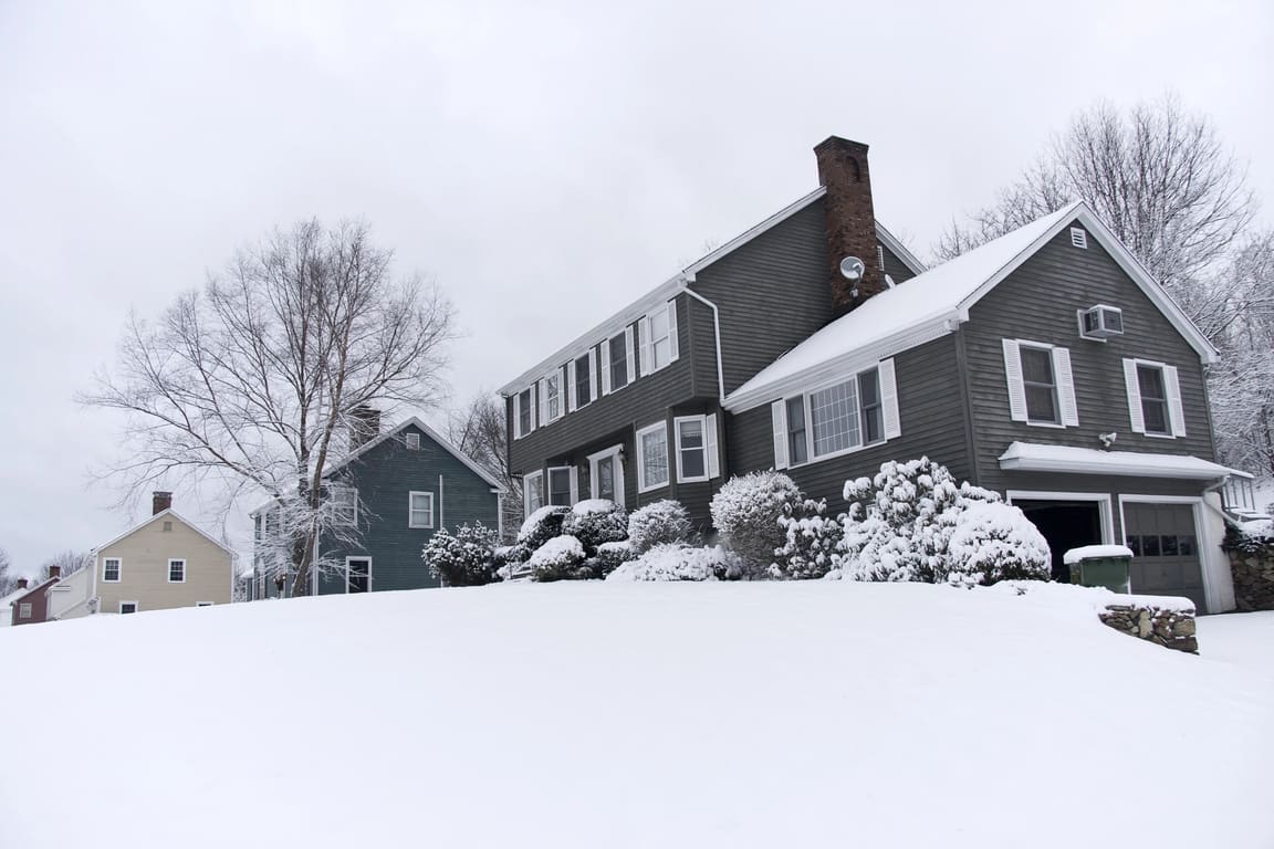 Shingled colonial houses after a fresh snowfall